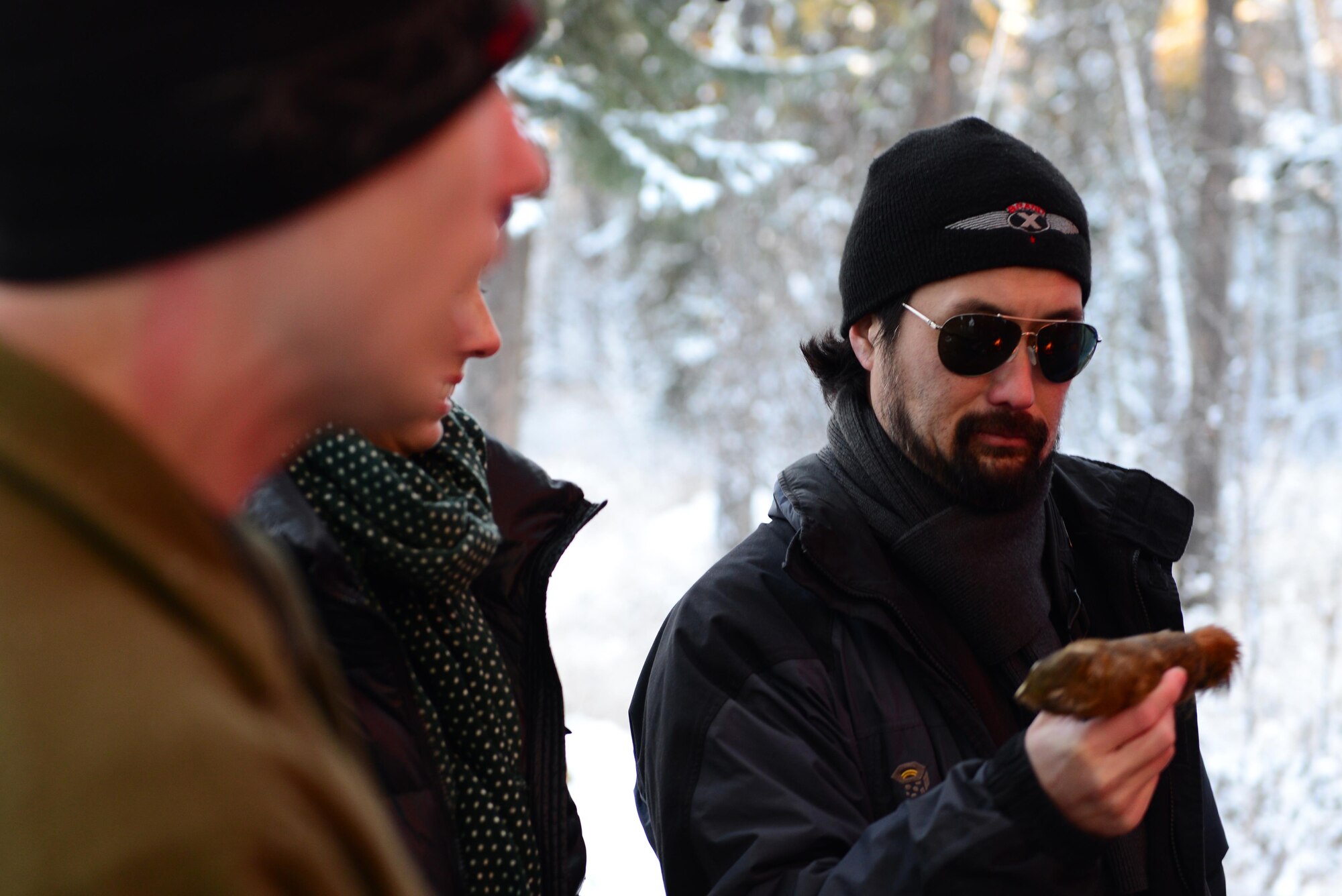 Kent Matsuoka, a production and location manager, holds a squirrel during a lesson on arctic survival Oct. 25, 2016, at the Arctic Survival School on Eielson Air Force Base, Alaska. Matsuoka and others were taught how to catch and prepare food in the arctic as part of a civic leader tour. (U.S. Air Force photo by Airman Eric M. Fisher)