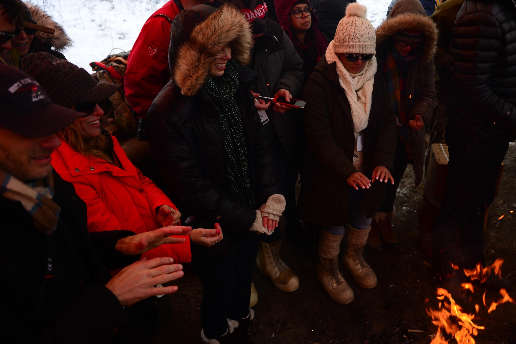 Hollywood civic leaders huddle around a fire after a day at the Arctic Survival School, Oct. 25, 2016, at Eielson Air Force Base, Alaska. The Civic Leader Tour was an opportunity to showcase Eielson’s mission to leaders of the public. (U.S. Air Force photo by Airman Eric M. Fisher)