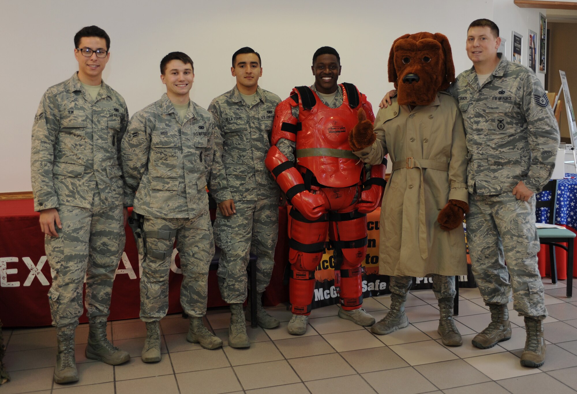 Members from the 28th Security Forces Squadron pose for a photo with McGruff the Crime Dog during a Red Suit demonstration at Ellsworth Air Force Base, S.D., Oct. 12, 2016. The 28th SFS celebrated National Crime Prevention Month as a way to educate families about protecting themselves from being a victim of any crime. (U.S. Air Force photo by Airman 1st Class Denise M. Jenson)
