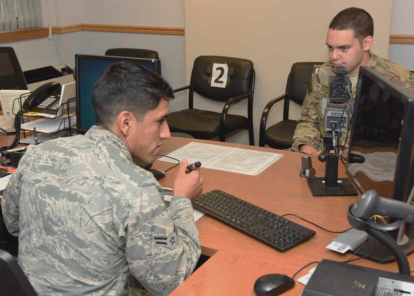Airman 1st Class Jorge Guzman, 341st Force Support Squadron Military Personnel Section assists Senior Airman Juan Feliciano, 341st Missile Security Forces Squadron, in getting a new military ID card, Oct. 27, 2016.  The 341st FSS Military Personnel Section recently won the Gerrit D. Foster, Jr. Outstanding Military Personnel Program Award for the second time in two years.  (U.S. Air Force photo/Jason Heavner)