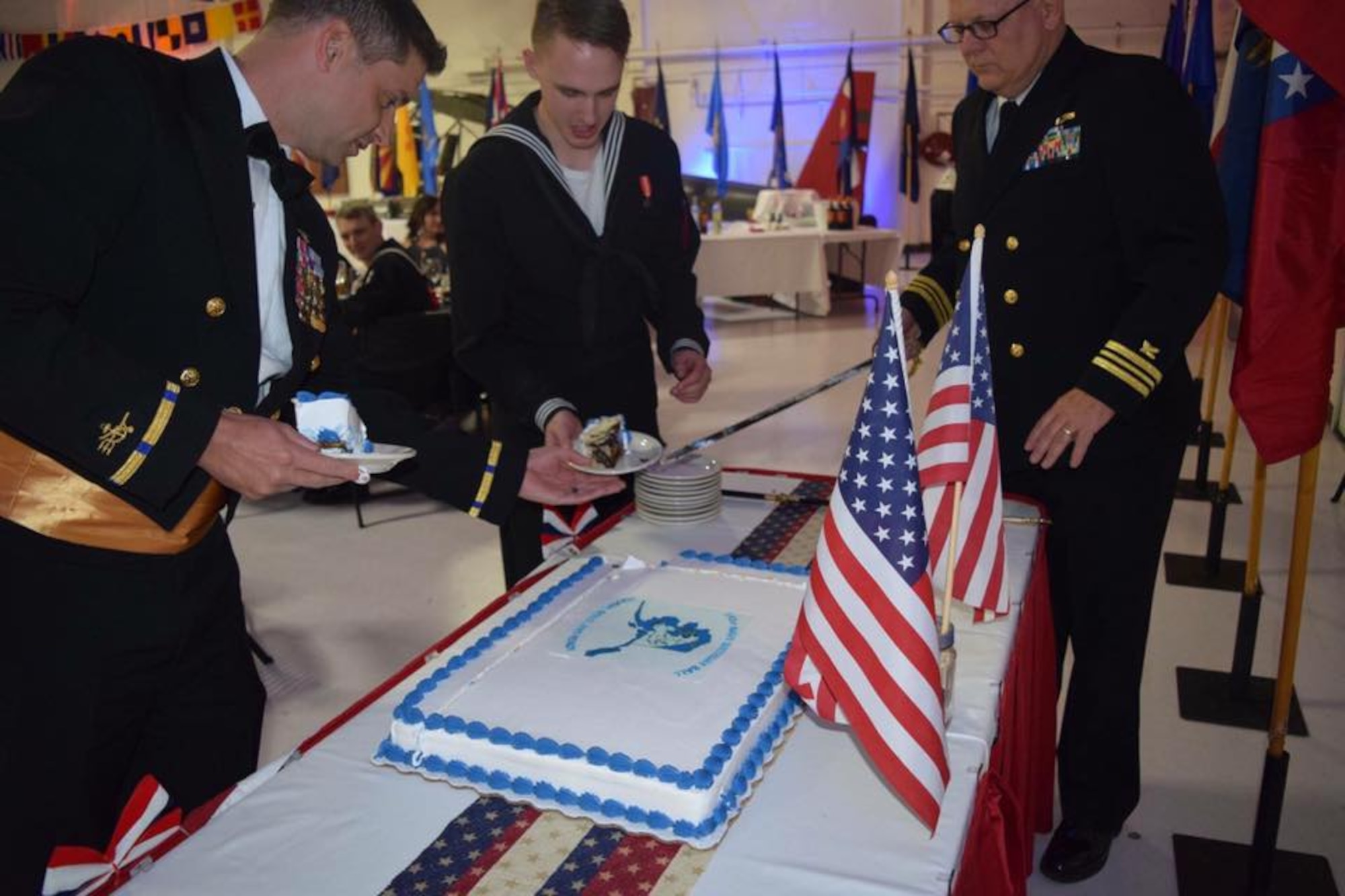 Chief Warrant Officer Jeffrey Bull (SEAL) from Navy Special Warfare detachment, Kodiak receives the first slice of cake as the guest of honor at Alaska's 2016 Navy Ball. This year, the oldest and the youngest member, Lt. Cmdr. Jere Hawn and Seaman Alan Beacham cut the cake in honor of the 241st birthday celebration. 
