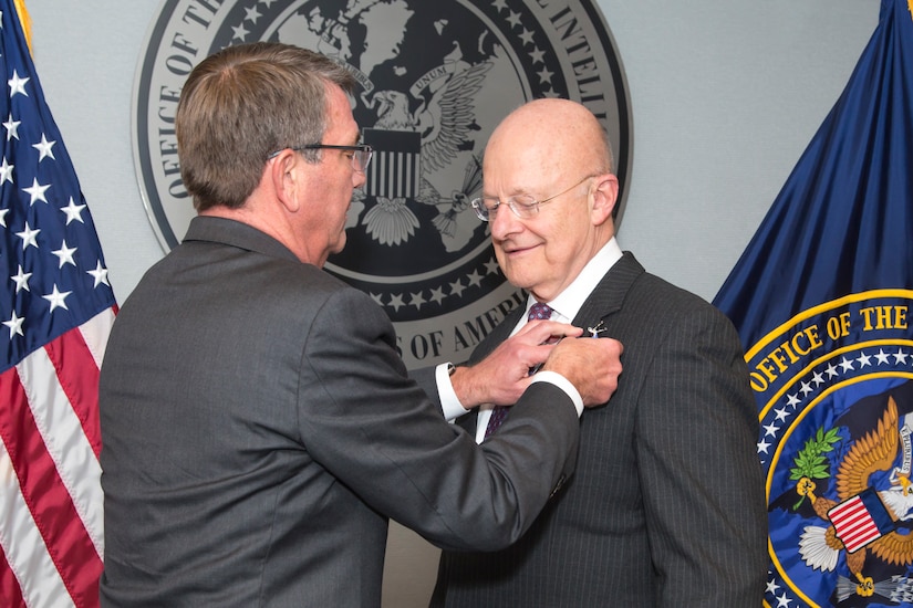 Defense Secretary Ash Cater presents James R. Clapper, the director of the Office of National Intelligence, with the Defense Distinguished Civilian Service Medal at a ceremony at the office’s headquarters in Tysons Corner, Va., Oct. 28, 2016. Office of the Director of National Intelligence photo