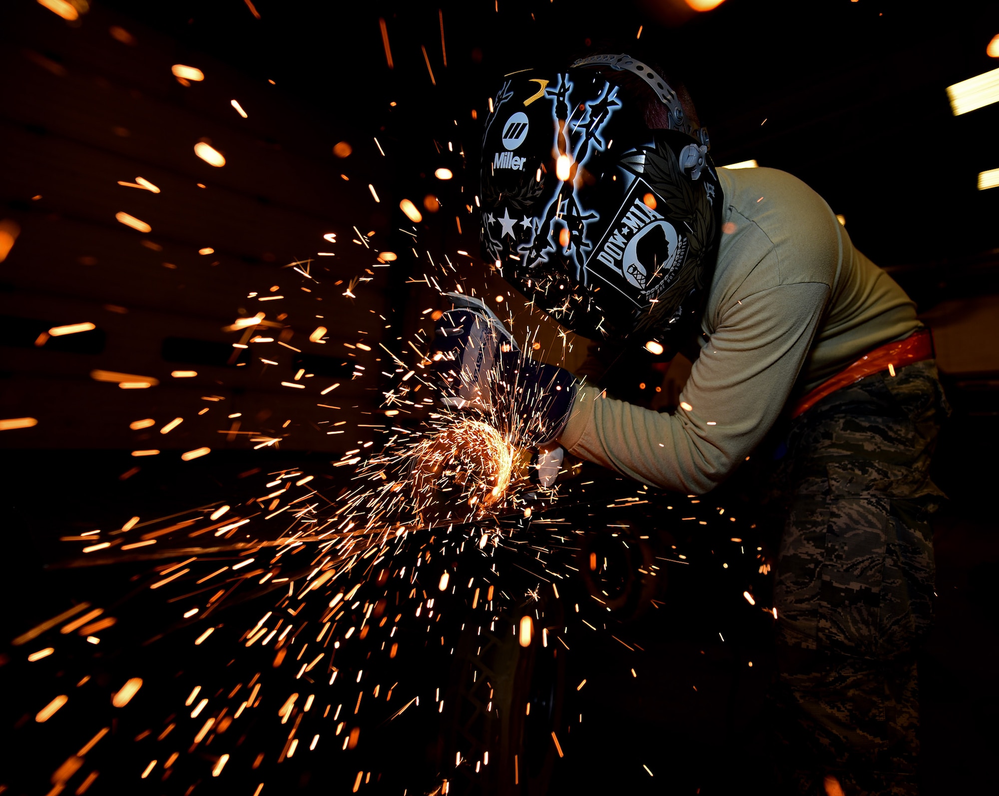 Senior Airman Kyle Eberhart, an aircraft metals technology journeyman assigned to the 28th  Maintenance Squadron, uses a grinder to cut a piece of metal to size for a trailer bed at Ellsworth Air Force Base, S.D., Oct. 27, 2016.  The trailer is one of many types of munitions support equipment that metals tech Airmen help  repair and create replacement parts for, saving the Air Force millions of dollars each year. (U.S. Air Force photo by Airman 1st Class James L. Miller)