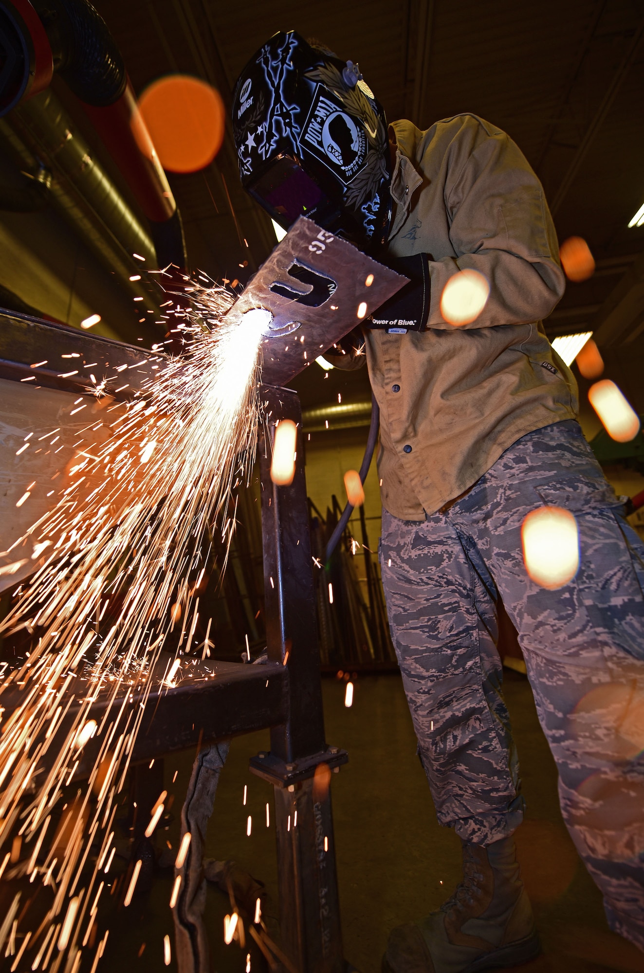 Senior Airman Kyle Eberhart, an aircraft metals technology journeyman assigned to the 28th Maintenance Squadron, etches out letters with a plasma cutter at Ellsworth Air Force Base, S.D., Oct. 27, 2016. Accurate cuts are not only visually appealing, but also increase the lifespan of parts, ensuring the sustainment of aircraft and the success of the 28th Bomb Wing’s mission. (U.S. Air Force photo by Airman 1st Class James L. Miller)