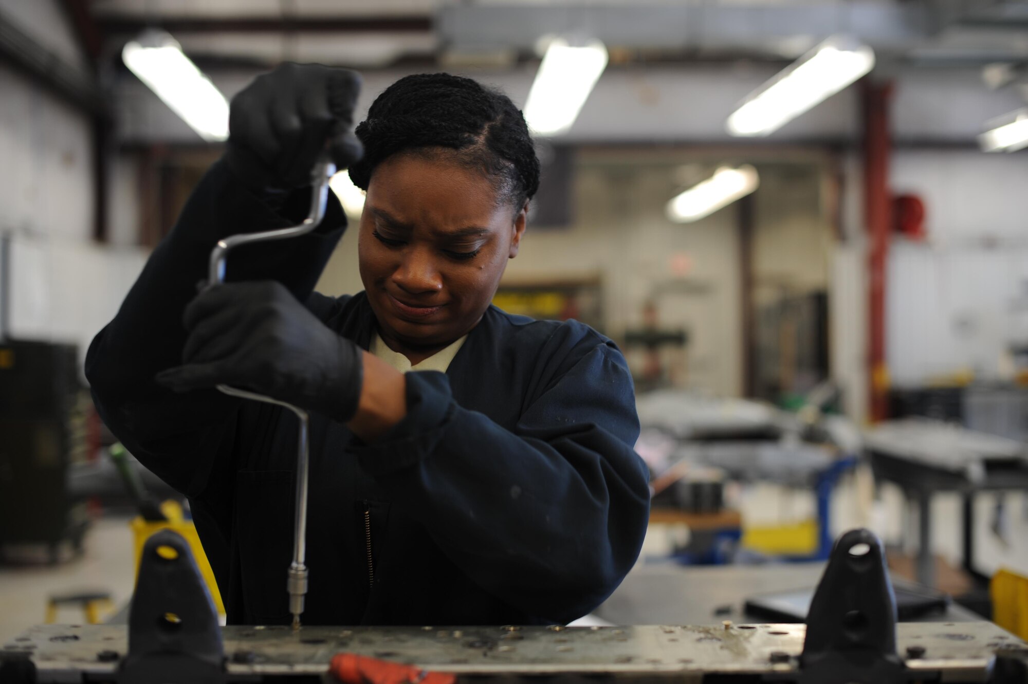U.S. Air Force Staff Sgt. Taijah Jenkins, 355th Aircraft Maintenance Squadron armament flight supervisor, installs a side plate onto a triple ejector bomb rack at Davis-Monthan Air Force Base, Ariz., Oct. 19, 2016. The bomb rack must be torn down and inspected regularly to ensure functionality in training and real-world conflict environments. (U.S. Air Force photo by Airman 1st Class Ashley N. Steffen)   