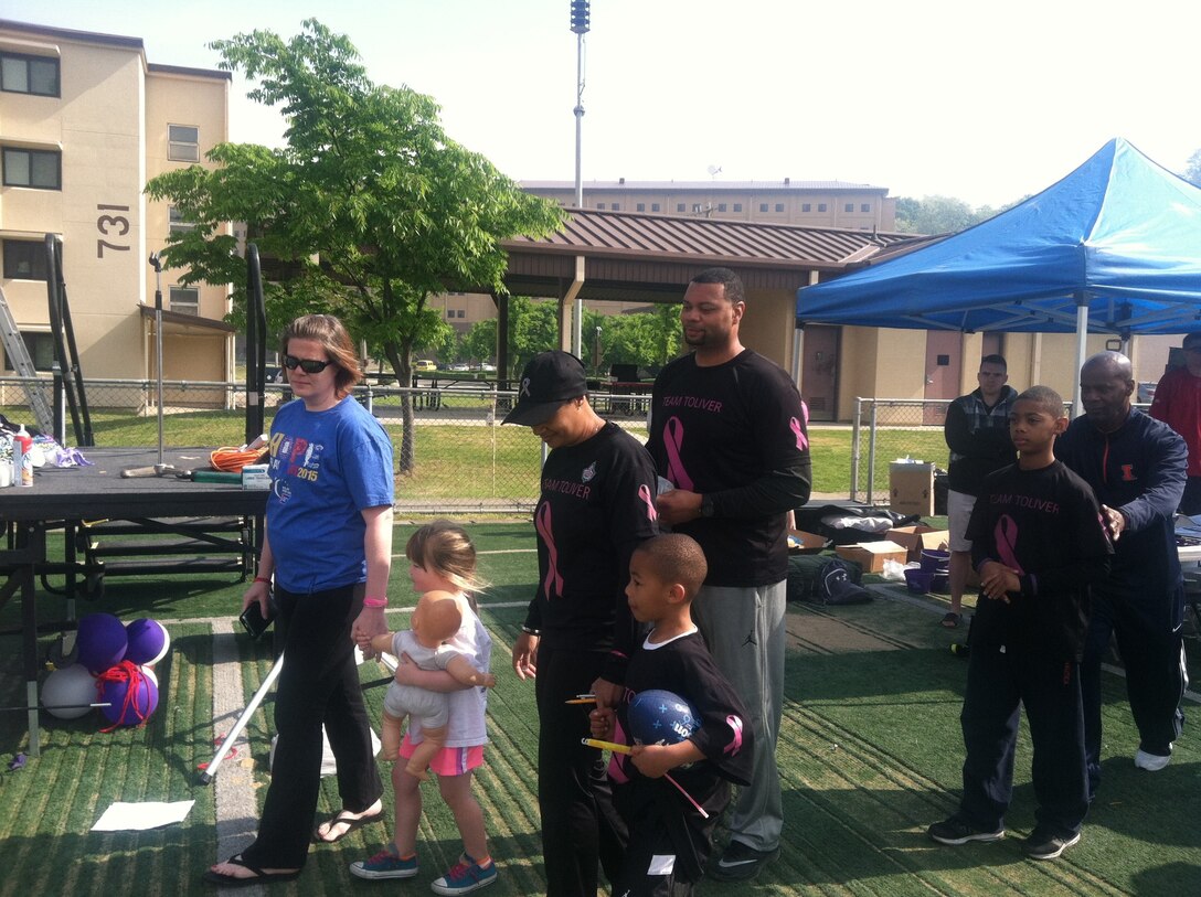 U.S. Air Force Lt. Col. Shamekia Toliver, 7th Civil Engineer Squadron commander, and her family, center, participate at a Relay for Life event at Osan Air Base, Korea, May 16, 2015. Toliver and her family, who she affectionately ‘Team Toliver’, partook in the event to raise awareness for breast cancer. Toliver was diagnosed with breast cancer while stationed at Osan, where she chose to stay to undergo treatment and continue serving as the 51st Civil Engineer Squadron deputy commander. (Courtesy photo)