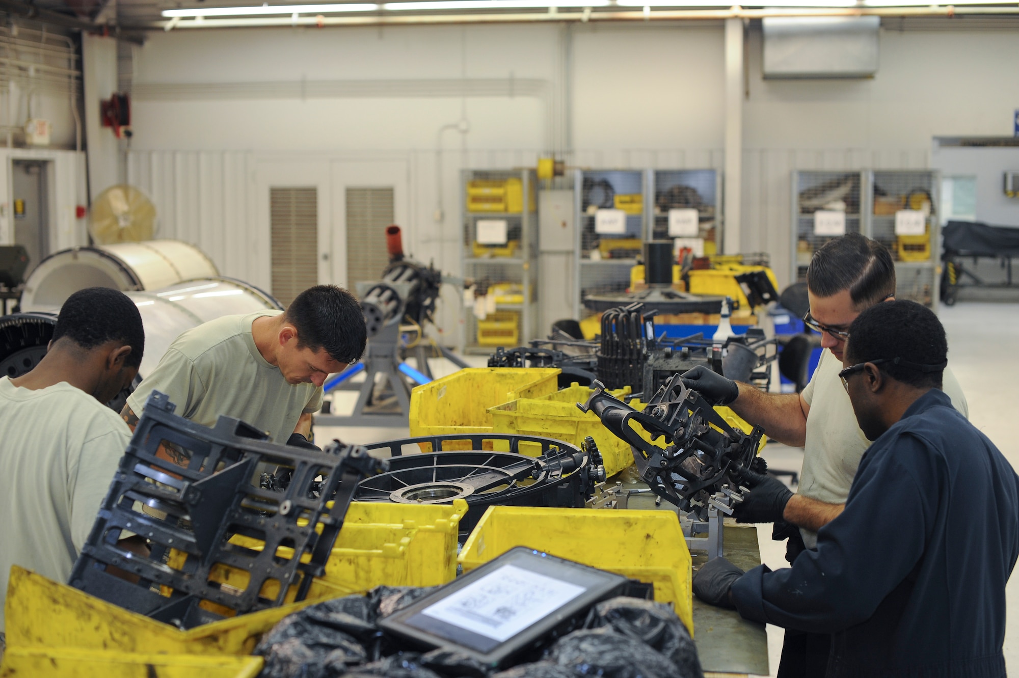 U.S. Airmen from the 924th Maintenance Squadron, team up with members from the 355th Equipment Maintenance Squadron armament flight, to reassemble GAU-8/A Gatling gun components at Davis-Monthan Air Force Base, Ariz., Oct. 25, 2016. The Airmen work together in the armament shop to guarantee weapon systems are properly cleaned, inspected and reassembled in order to keep up with mission demands. (U.S. Air Force photo by Airman 1st Class Ashley N. Steffen)