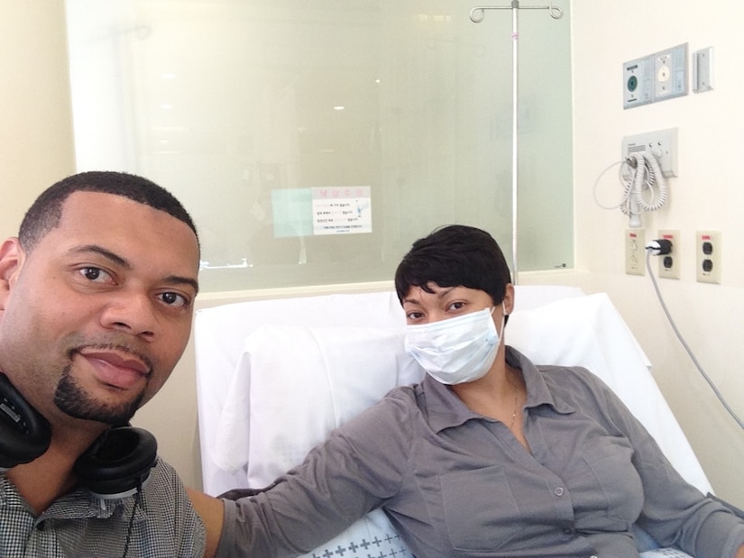 U.S. Air Force Lt. Col. Shamekia Toliver, 7th Civil Engineer Squadron commander, and her husband, James, take a photo during a hospital appointment when she was stationed at Osan Air Base, Korea in 2014. Her husband found the lump in her breast, which ultimately saved her life. (Courtesy photo)