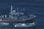 A Station South Padre Island boat crew pulls alongside a Lancha caught fishing illegally in gulf waters, Texas Dec. 11, 2015. Lanchas are Mexican fishing boats that poach thousands of pounds of wildlife from U.S. waters every year. (U.S. Coast Guard photo by Air Station Corpus Christi)