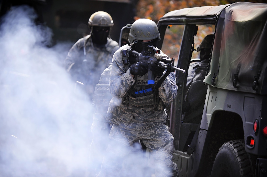 Airmen provide security under the cover of smoke during tactical combat casualty care training at Francis S. Gabreski Airport in Westhampton Beach, N.Y., Oct. 21, 2016. Air National Guard photo by Staff Sgt. Christopher S. Muncy



