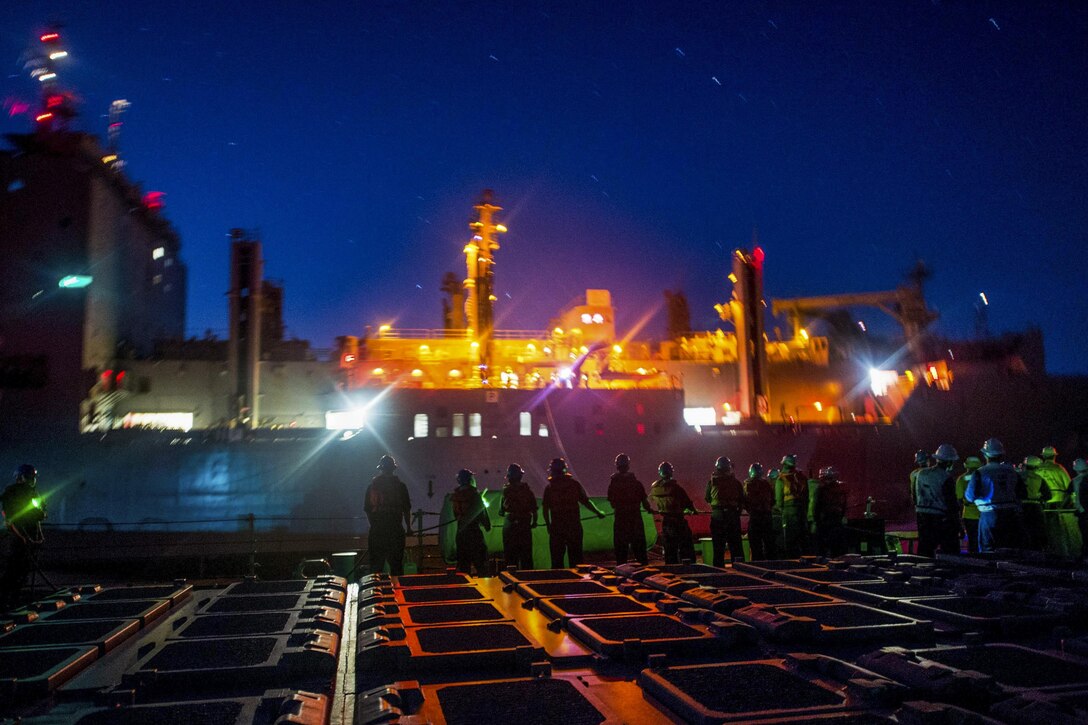 Sailors assigned the guided-missile destroyer USS Barry heave a line on the aft missile deck during a replenishment with the USNS Charles Drew in the Philippine Sea, Oct. 25, 2016. The Barry is supporting security and stability in the Indo-Asia-Pacific region. Navy photo by Petty Officer 2nd Class Kevin V. Cunningham