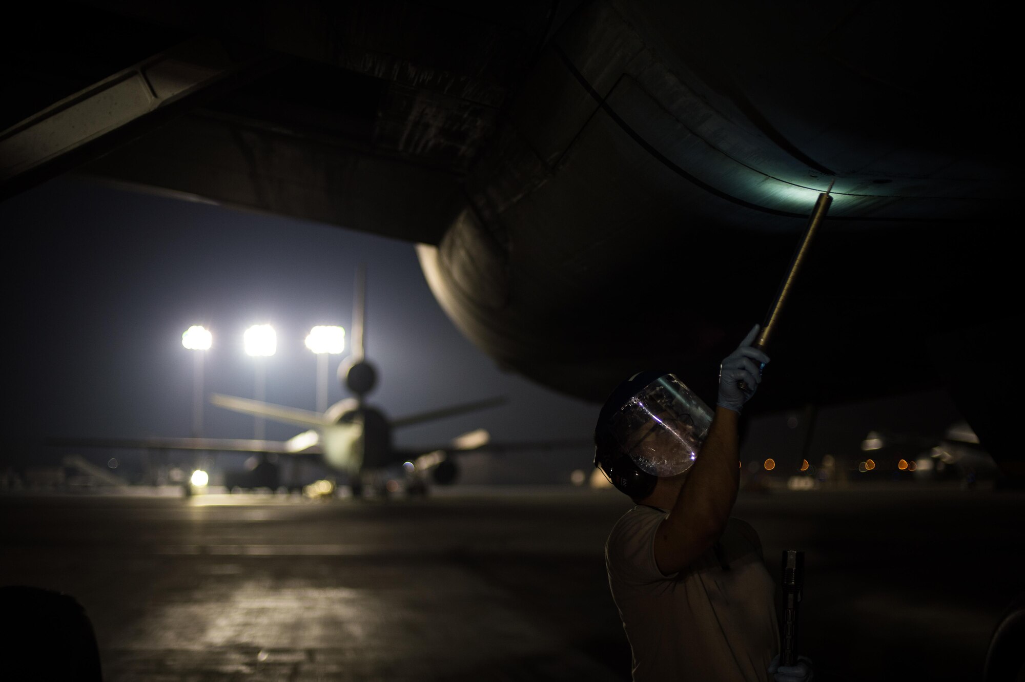 Airman 1st Class Richard, a KC-10 Extender fuel systems specialist, completes a fuels system inspection with a drain tool at an undisclosed location in Southwest Asia, Oct. 26, 2016. The KC-10s continue their support as they assist U.S. and allied forces in the liberation of Mosul, Iraq. (U.S. Air Force photo by Senior Airman Tyler Woodward)