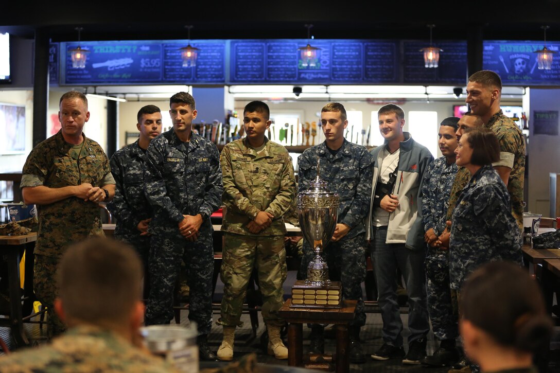 Col. Todd Ferry speaks to Marines and Sailors before awarding the prestigious intramural sports trophy to Naval Health Clinic Cherry Point aboard Marine Corps Air Station Cherry Point, N.C., Oct. 27, 2016. Cherry Point’s Semper Fit program annually re-awards the trophy to the unit aboard the air station that wins the most championships throughout the year. Some of the sports they participated in include softball, basketball, football and soccer. Ferry is the MCAS Cherry Point commanding officer. (U.S. Marine Corps photo by Lance Cpl. Mackenzie Gibson/Released)