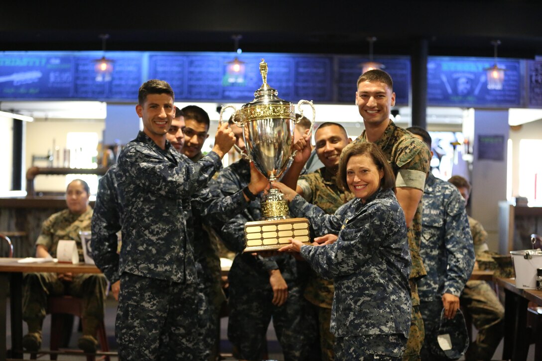 The Naval Health Clinic Cherry Point soccer team, along with Navy Capt. Angela Nimmo, celebrates winning the coveted Cherry Point intramural sports trophy aboard Marine Corps Air Station Cherry Point, N.C., Oct. 27, 2016. Cherry Point’s Semper Fit program annually re-awards the trophy to the unit aboard the air station that wins the most championships throughout the year. Some of the sports they participated in include softball, basketball, football and soccer. Nimmo is the Naval Health Clinic Cherry Point commanding officer. (U.S. Marine Corps photo by Lance Cpl. Mackenzie Gibson/Released)