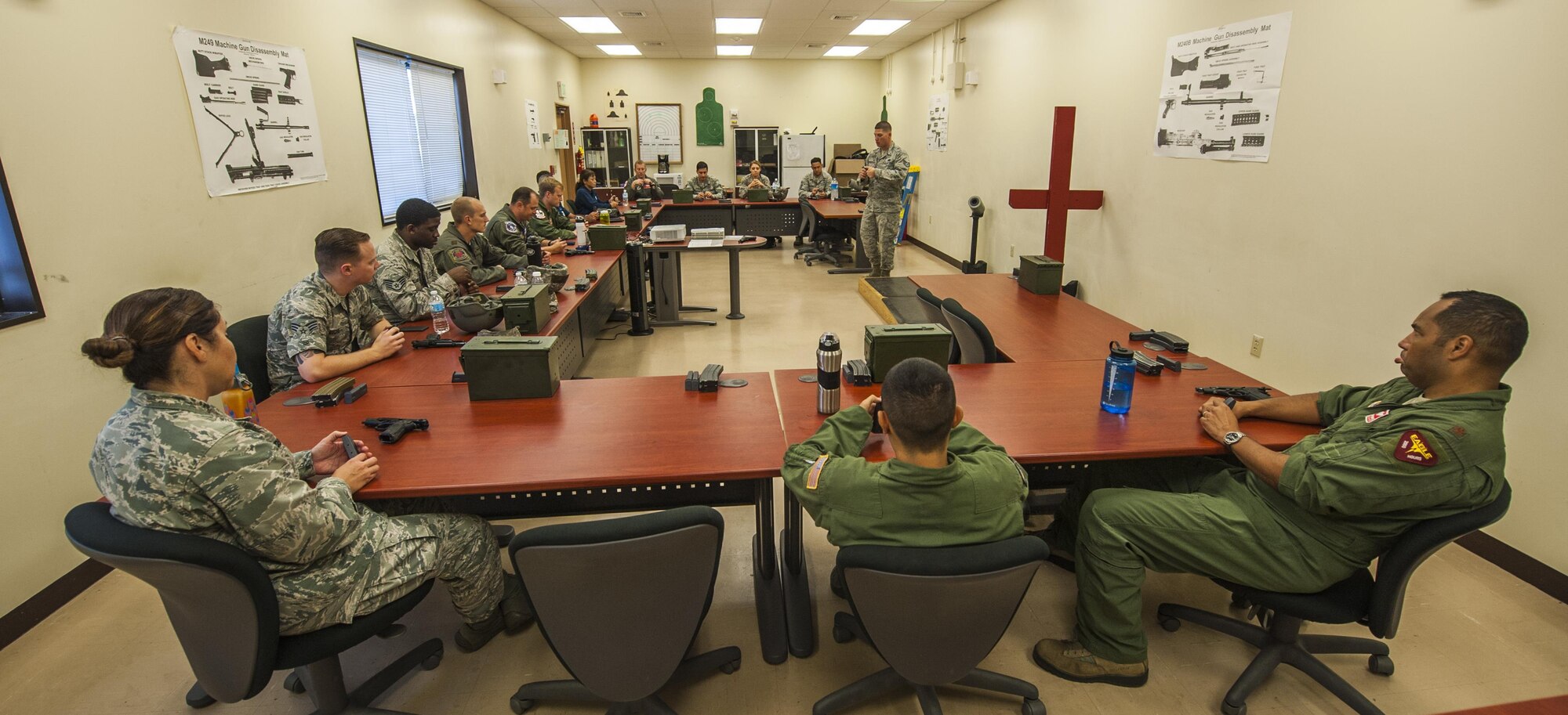 Members of Team Kadena receive instruction on proper use of the M9 Beretta prior to range qualifying at the firing range on Kadena Air Base, Japan, Oct. 25, 2016. Combat arms instructors are a shred out from security forces that help to train military members for weapon qualification. (U.S. Air Force photo by Airman 1st Class Nick Emerick) 