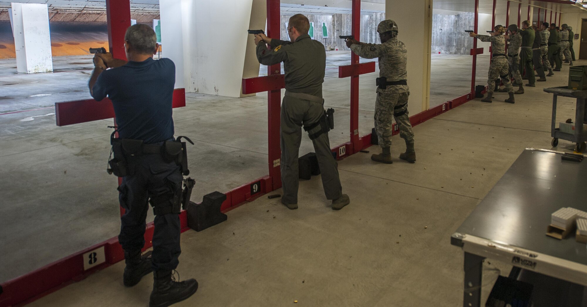 Okinawan contractors and military members fire on the shooting range at Kadena Air Base, Japan, Oct. 25, 2016. The training and safety of members on the firing line is very important to combat arms instructors. (U.S. Air Force photo by Airman 1st Class Nick Emerick)