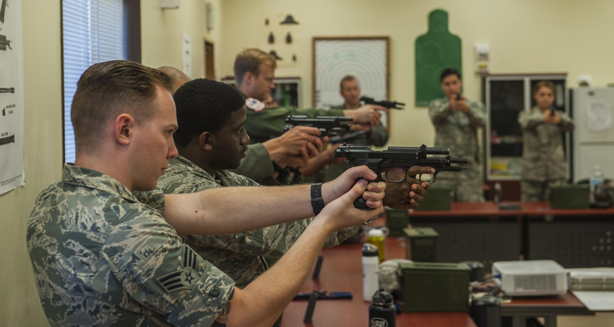 Members of a combat arms instruction class practice proper weapon procedures with M9 Berettas prior to range qualifying at the firing range on Kadena Air Base, Japan, Oct. 25, 2016. Combat arms instructors qualify military members on different weapons prior to events such as deployment. (U.S. Air Force photo by Airman 1st Class Nick Emerick)
