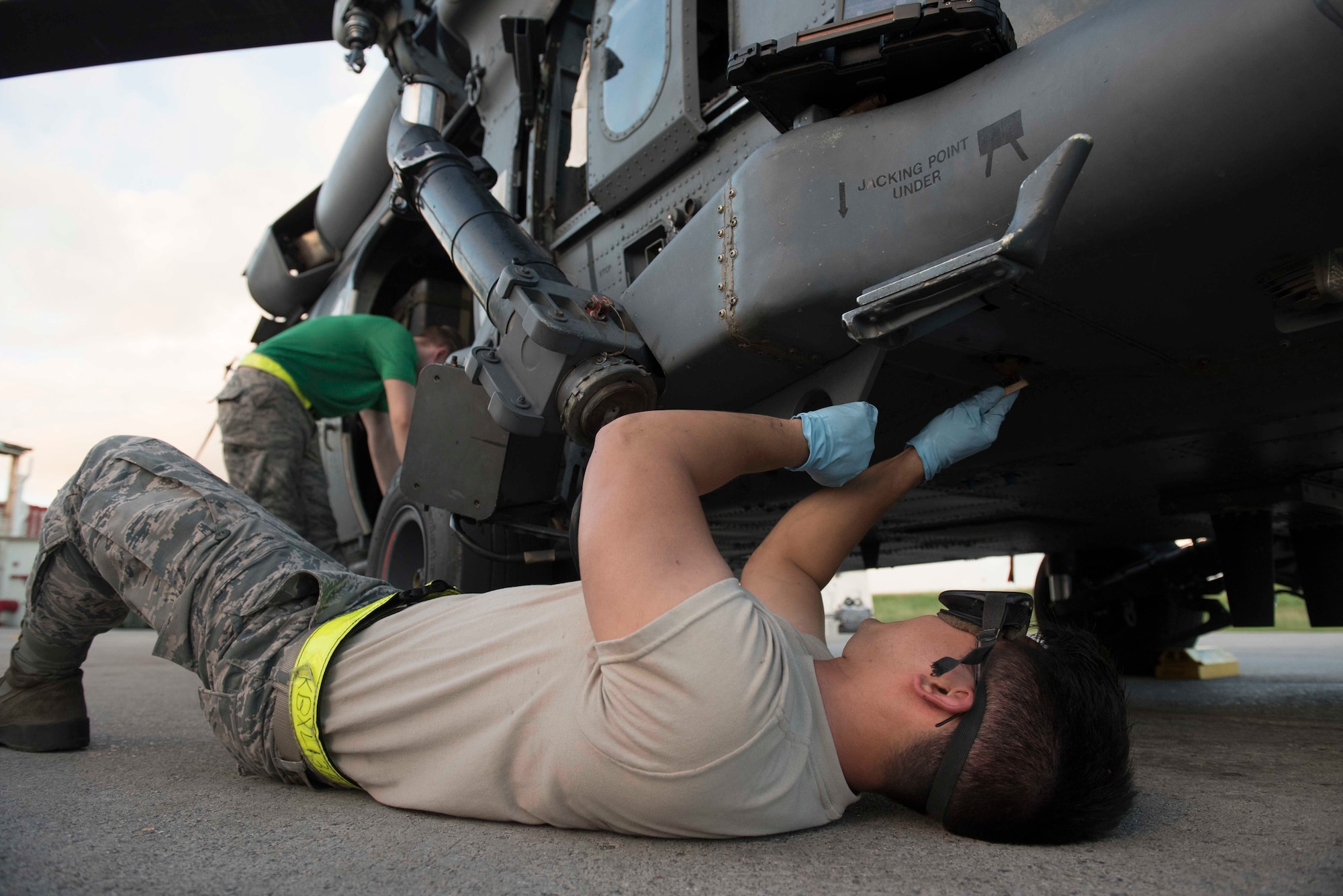 A maintainer from the 33d Helicopter Maintenance Unit, cleans an HH-60G Pave Hawk while checking for corrosion Oct. 25, 2016, at Kadena Air Base, Japan. The 33rd HMU supports the helicopters used by the 33rd Rescue Squadron maintainers to perform their operations.  (U.S. Air Force photo by Senior Airman Omari Bernard/Released)