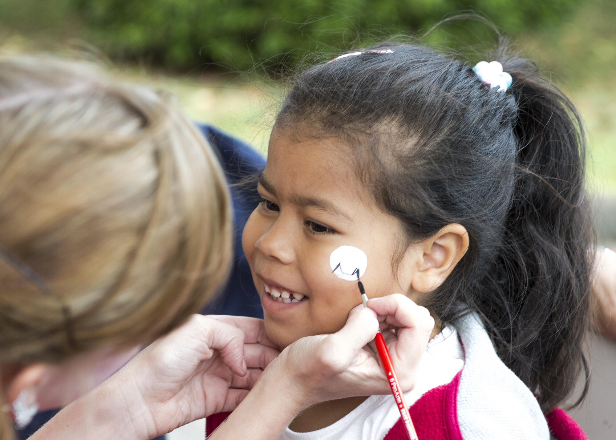 A child gets her face painted during the 374th Force Support Squadron’s Howl-O-Ween Pawty on Oct. 29, 2016, at Yokota Air Base, Japan. The event included activities and games for families, including: sumo wrestling suits, bounce castle and a performance by the French-Polynesian dance group Taputea. (U.S. Air Force photo by Airman 1st Class Donald Hudson/Released)