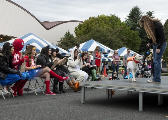 Participant in the 374th Force Support Squadron’s Howl-O-Ween Pawty costume contest show pets to judges on Oct. 29, 2016, at Yokota Air Base, Japan. The family event gave over 60 participants the chance to meet other pet owners from around the base. (U.S. Air Force photo by Airman 1st Class Donald Hudson/Released)