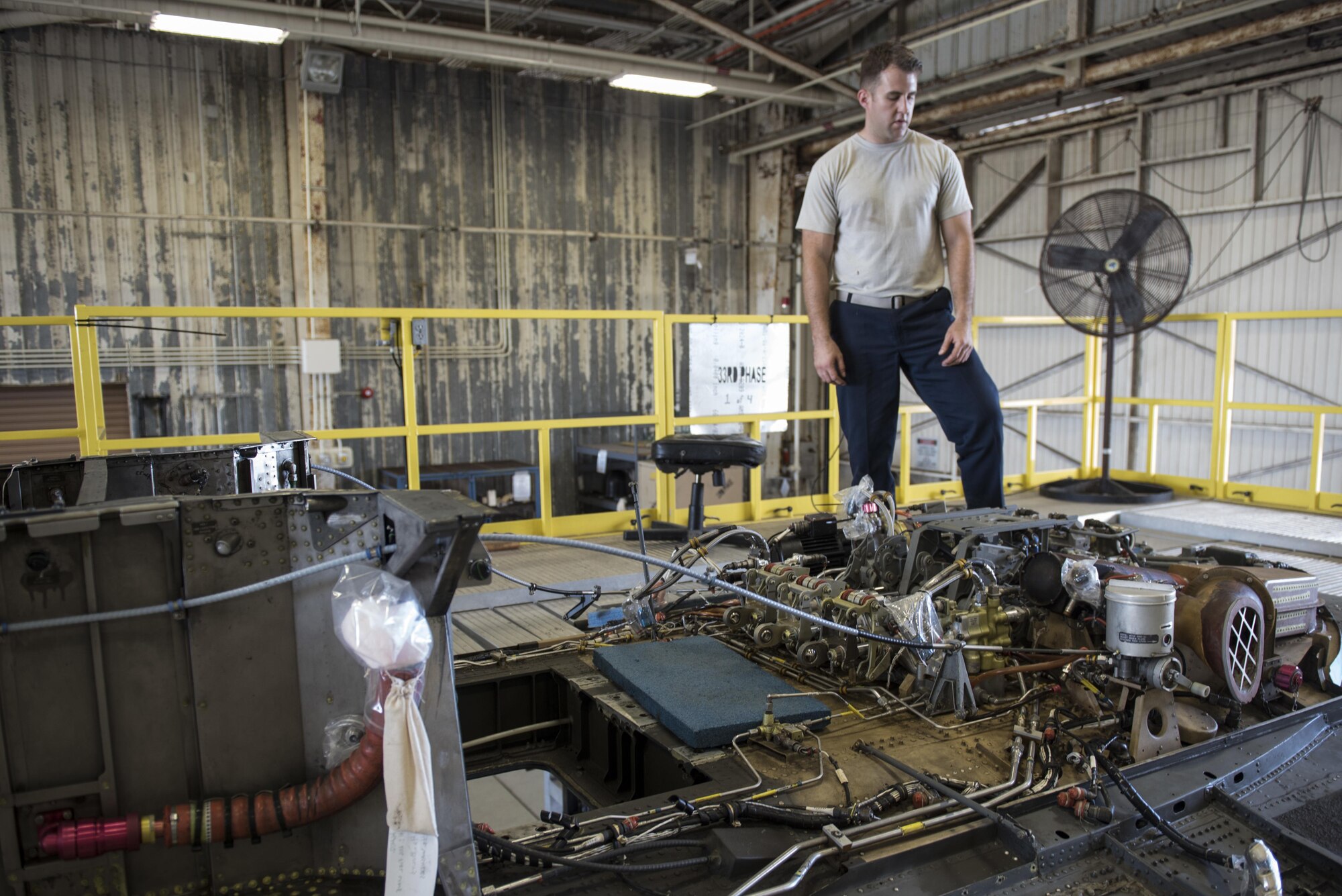 U.S. Air Force Senior Airman Timothy Boling, 33rd Helicopter Maintenance Unit HH-60G crewchief, inspects the roof of an HH-60G Pavehawk during a phase inspection Oct. 26, 2016, at Kadena Air Base, Japan. During the phase inspection crewchiefs examine every inch of the aircraft to ensure serviceability. (U.S. Air Force photo by Senior Airman Omari Bernard)