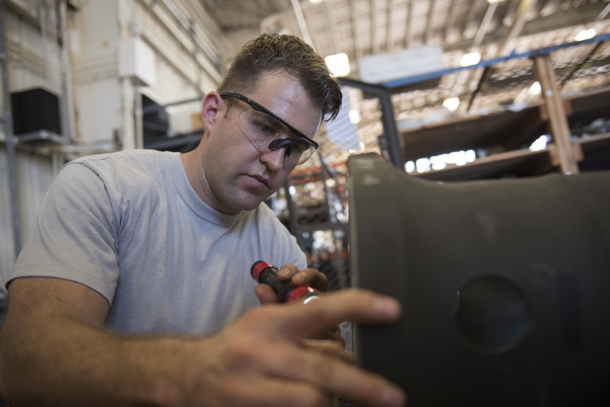 U.S. Air Force Senior Airman Timothy Boling, 33rd Helicopter Maintenance Unit HH-60G crewchief, inspects parts of an HH-60G Pavehawk during a phase inspection Oct. 26, 2016. Boling checks for cracks, corrosion and other signs of damage to the part. (U.S. Air Force photo by Senior Airman Omari Bernard)