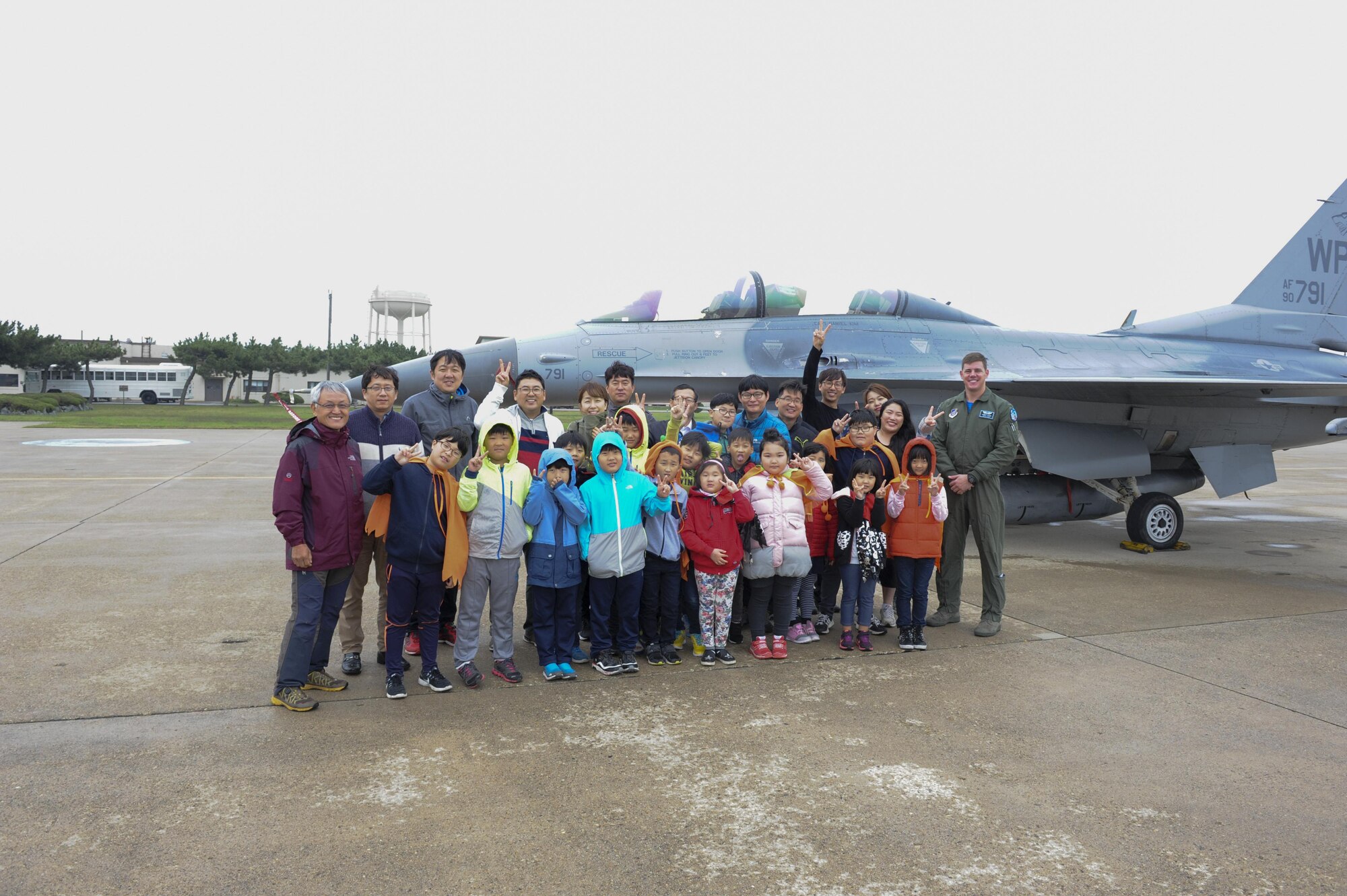 Children from Sinsido elementary school stand in front of an F-16 Fighting Falcon at Kunsan Air Base, Republic of Korea, Oct.28, 2016. The children participated in a base tour that included a trick-or-treat Halloween event. (U.S. Air Force photo by Senior Airman Michael Hunsaker/Released)