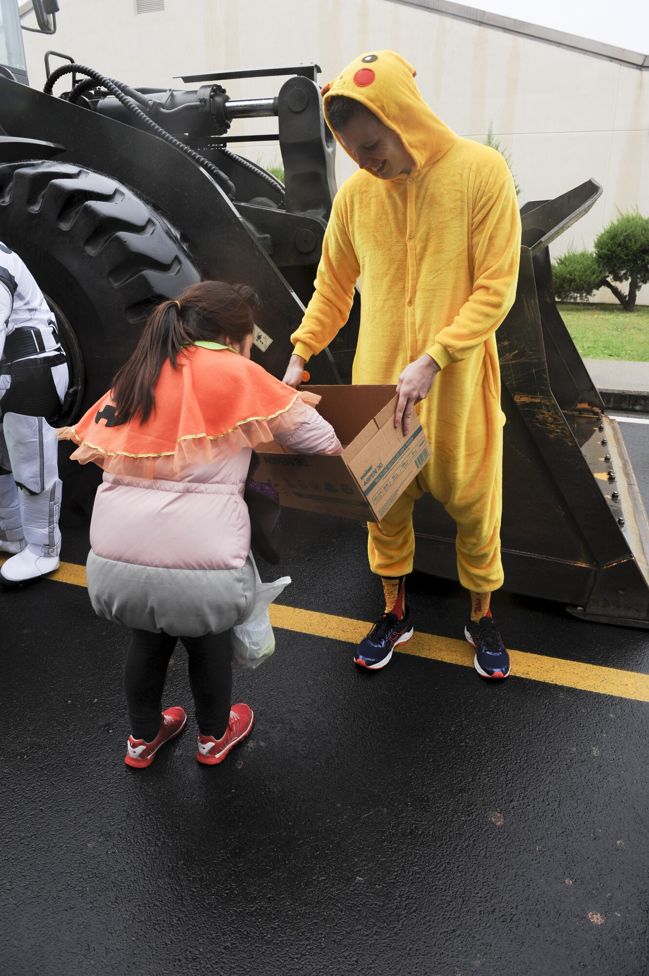 Staff Sgt. Justin Prince, 8th Comptroller Squadron special actions noncommissioned officer, hands out candy to children from Sinsido elementary school at Kunsan Air Base, Republic of Korea, Oct. 28, 2016. The children participated in a base tour that included a trick-or-treat Halloween event. (U.S. Air Force photo by Senior Airman Michael Hunsaker/Released)