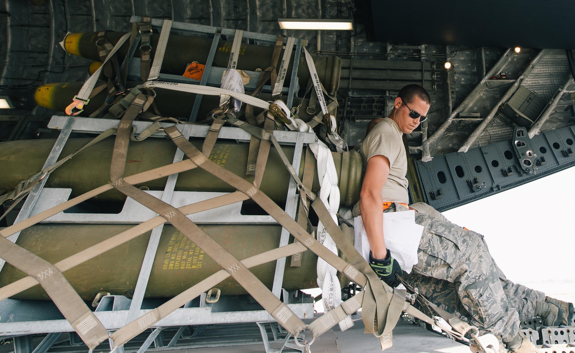 Airmen with the 8th Expeditionary Air Mobility Squadron push cargo into an 816th Expeditionary Airlift Squadron C-17 Globemaster III in support of Combined Joint Task Force - Operation Inherent Resolve at Al Udeid Air Base, Qatar, Oct. 28, 2016. These squadrons are actively engaged in tactical airlift operations supporting the Mosul offensive. (U.S. Air Force photo by Senior Airman Jordan Castelan)