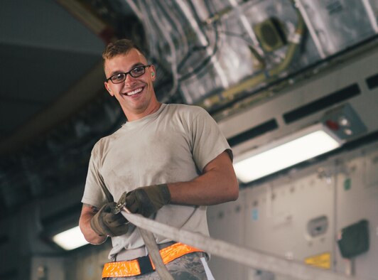 An Airman with the 8th Expeditionary Air Mobility Squadron helps secure a tie down on an 816th Expeditionary Airlift Squadron C-17 Globemaster III in support of Combined Joint Task Force - Operation Inherent Resolve at Al Udeid Air Base, Qatar, Oct. 28, 2016. The 8th EAMS plans, supplies and distributes worldwide expeditionary combat support throughout the U.S. Air Forces Central Command area of operations. (U.S. Air Force photo by Senior Airman Jordan Castelan)