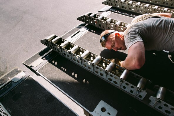 An Airman with the 8th Expeditionary Air Mobility Squadron helps secure cargo rollers onboard an 816th Expeditionary Airlift Squadron C-17 Globemaster III in support of Combined Joint Task Force - Operation Inherent Resolve at Al Udeid Air Base, Qatar, Oct. 28, 2016. These squadrons are actively engaged in tactical airlift operations supporting the Mosul offensive. (U.S. Air Force photo by Senior Airman Jordan Castelan)