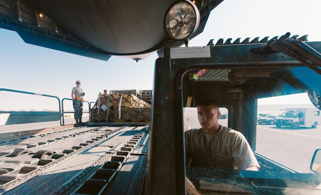 Airmen with the 8th Expeditionary Air Mobility Squadron load cargo onto an 816th Expeditionary Airlift Squadron C-17 Globemaster III in support of Combined Joint Task Force - Operation Inherent Resolve at Al Udeid Air Base, Qatar, Oct. 28, 2016. These squadrons are actively engaged in tactical airlift operations supporting the Mosul offensive. (U.S. Air Force photo by Senior Airman Jordan Castelan)