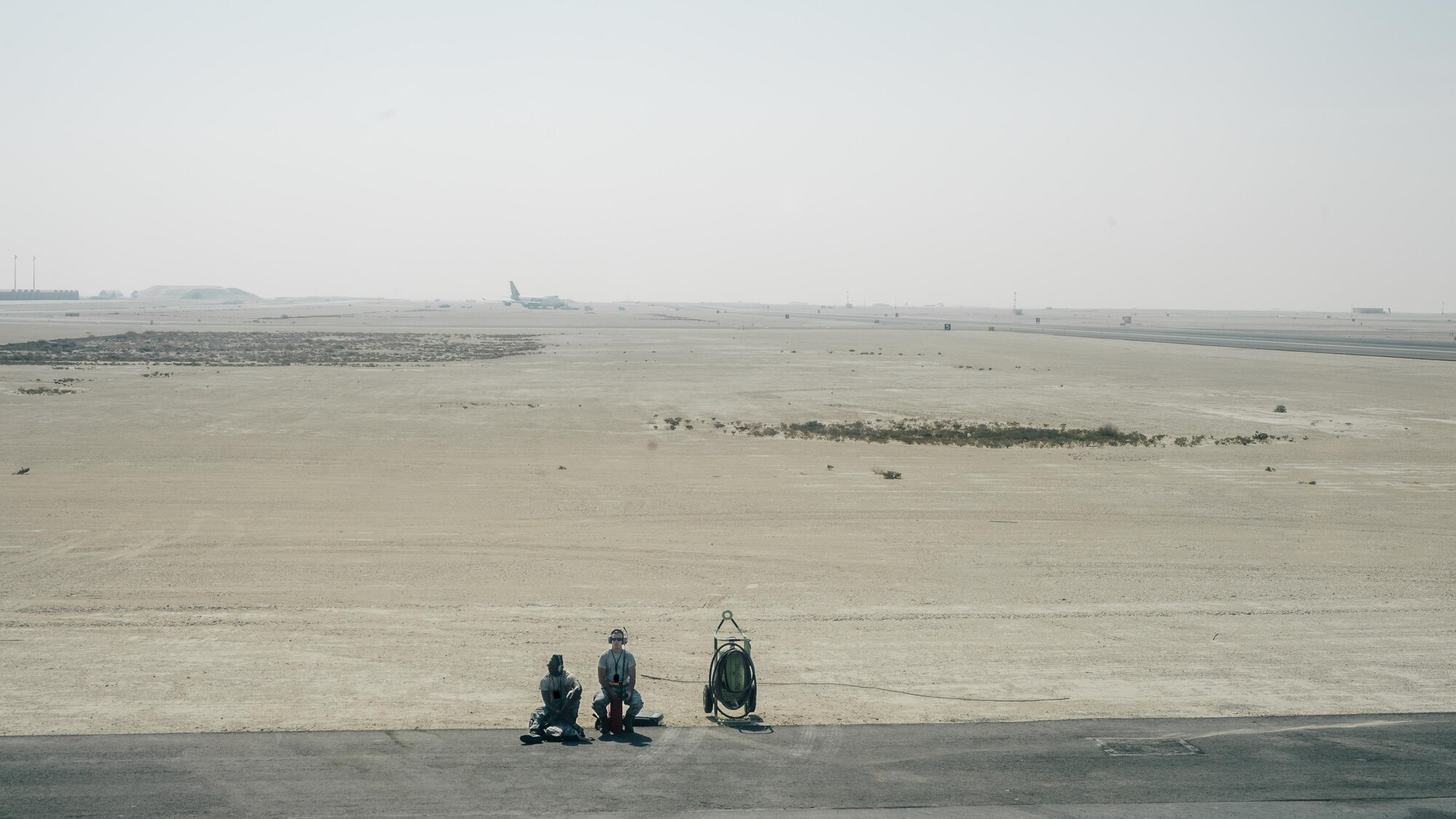 Airmen with the 8th Expeditionary Air Mobility Squadron wait for an 816th Expeditionary Airlift Squadron C-17 Globemaster III in support of Combined Joint Task Force - Operation Inherent Resolve to complete preflight checks at Al Udeid Air Base, Qatar, Oct. 28, 2016. These squadrons are actively engaged in tactical airlift operations supporting the Mosul offensive. (U.S. Air Force photo by Senior Airman Jordan Castelan)