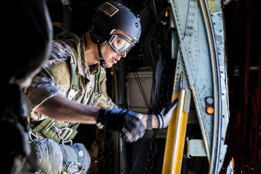 Air Force Staff Sgt. Justin Bender prepares to exit a C-130 Hercules aircraft during a static line jump over Yokota Air Base, Japan, Oct. 26, 2016. Bender is a survival, evasion, resistance and escape specialists assigned to the 374th Operations Support Squadron. Air Force photo by Airman 1st Class Donald Hudson