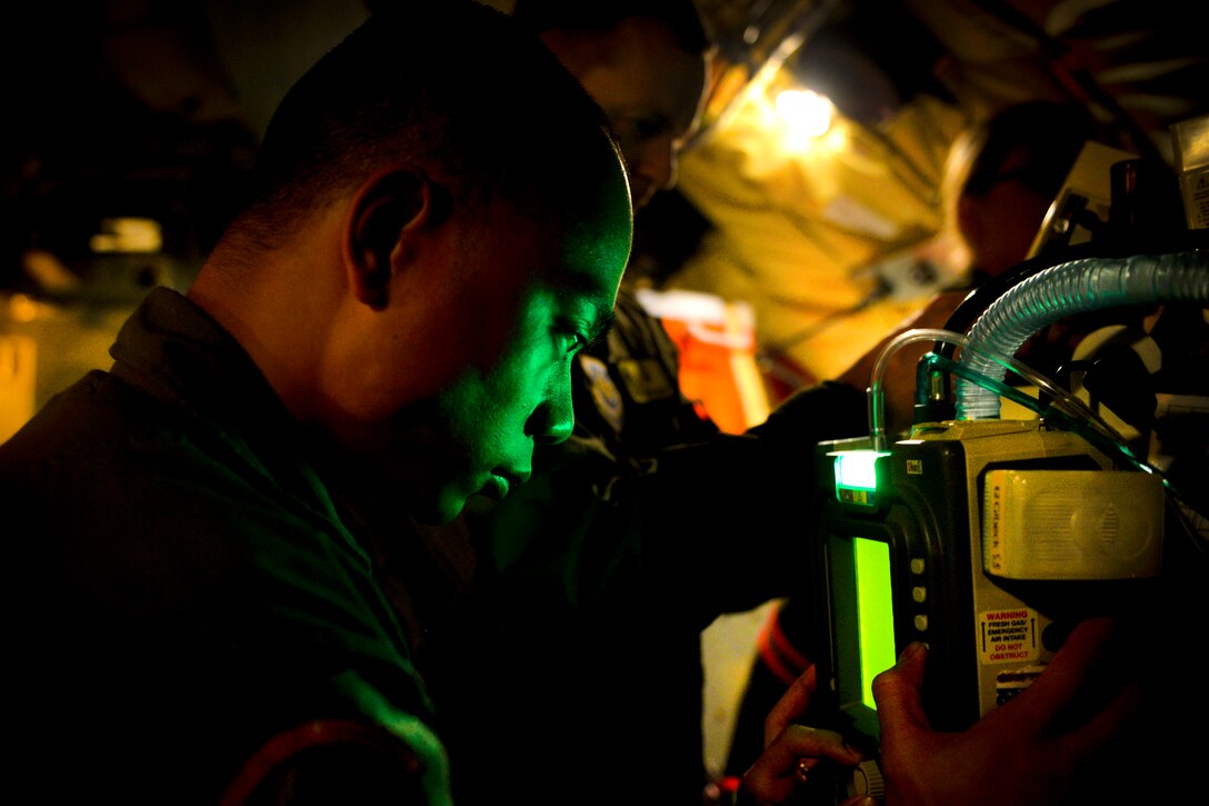 Air Force Senior Airman Chris Caniaveral monitors a critical care unit during an aeromedical evacuation training scenario for Southern Strike 17 at the Gulfport Combat Readiness Training Center, Miss., Oct. 26, 2016. Caniaveral is a respiratory therapist assigned to the 60th Surgical Operations Squadron. Air Force photo by Staff Sgt. Michael Battles