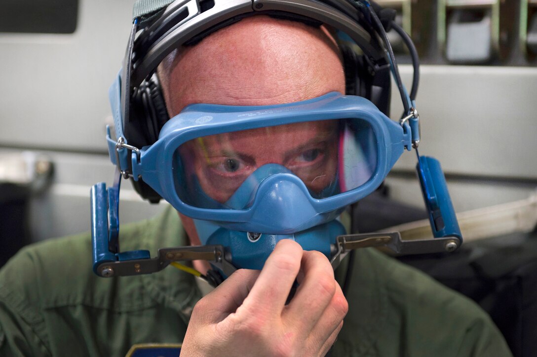 Air Force Tech. Sgt. Joe Harper dons an oxygen mask in response to a simulated in-flight fire training scenario during Southern Strike 17 at the Gulfport Combat Readiness Training Center, Miss., Oct. 26, 2016. Harper is a medical technician assigned to the 167th Aeromedical Evacuation Squadron. Air Force photo by Staff Sgt. Sean Martin