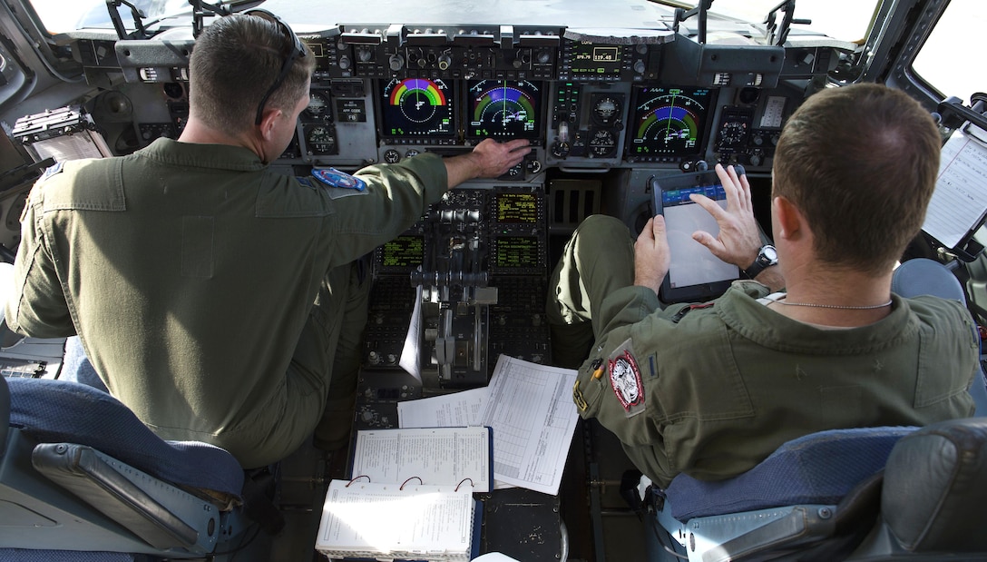 Air Force Capt. Tanner Summers, left, and 1st Lt. Jonathan Hildebrant perform pre-flight checks on their C-17 Globemaster III during Southern Strike 17 at the Gulfport Combat Readiness Training Center, Miss., Oct. 26, 2016. Both airmen are assigned to the 183rd Airlift Squadron. Air Force photo by Staff Sgt. Sean Martin