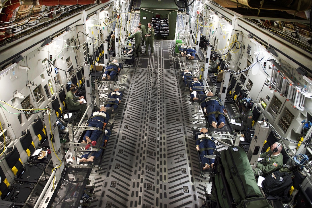 Air Force medical personnel transport simulated patients in a C-17 Globemaster III during an aeromedical evacuation training scenario for Southern Strike 17 over Gulfport Combat Readiness Training Center, Miss., Oct. 26, 2016. Air Force photo by Staff Sgt. Sean Martin