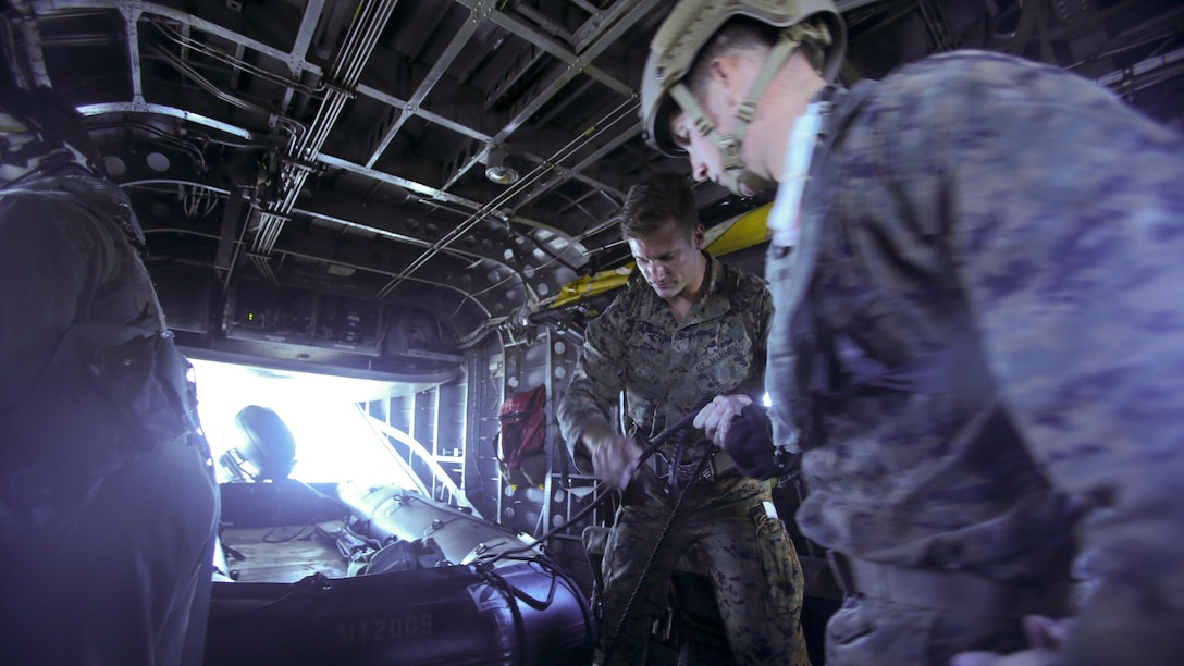 The Marines with 2nd Reconnaissance Battalion detach a zodiac boat from a CH-53E Super Stallion helicopter before jumping into ocean waters during a helocasting exercise at Camp Lejeune, N.C., Oct. 20, 2016. Helocasting is a means of insertion for sea to shore reconnaissance operations. 