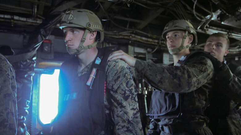 Marines with 2nd Reconnaissance Battalion.line up before soft-ducking, or dropping out an aircraft with a zodiac boat, during a helocasting exercise at Camp Lejeune, N.C., Oct. 20, 2016. They are required to know hand-and-arm signals to let them communicate before dropping into the water for sea to shore movements. 