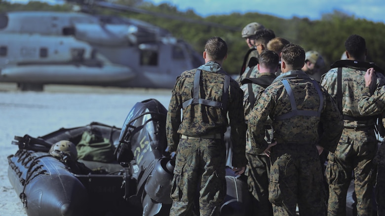 Marines with 2nd Reconnaissance Battalionwait to load a zodiac boat onto a CH-53E Super Stallion during a helocasting exercise at Camp Lejeune, N.C., Oct. 20, 2016.  Helocasting is a means of insertion for sea to shore reconnaissance operations.