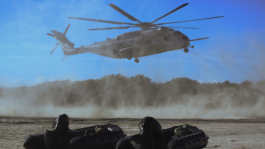 A CH-53E Super Stallion carries Marines, with 2nd Reconnaissance Battalion, out to sea to drop them into the surf during a helocasting exercise at Camp Lejeune, N.C., Oct. 20, 2016. During the helocasting the Marines practiced detaching a zodiac boat from inside a CH-53, jumping after it, and then working as a team to get into the zodiac and bring it back to shore.