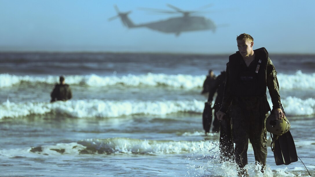 Marines with 2nd Reconnaissance Battalion emerge from the surf after dropping from a CH-53E Super Stallion and swimming ashore as part of a scout swimmer fin insertion during a helocasting exercise at Camp Lejeune, N.C., Oct. 20, 2016. During the exercise the Marines also practiced dropping with a zodiac boat, also known as soft-ducking, a means of insertion for sea to shore reconnaissance operations.