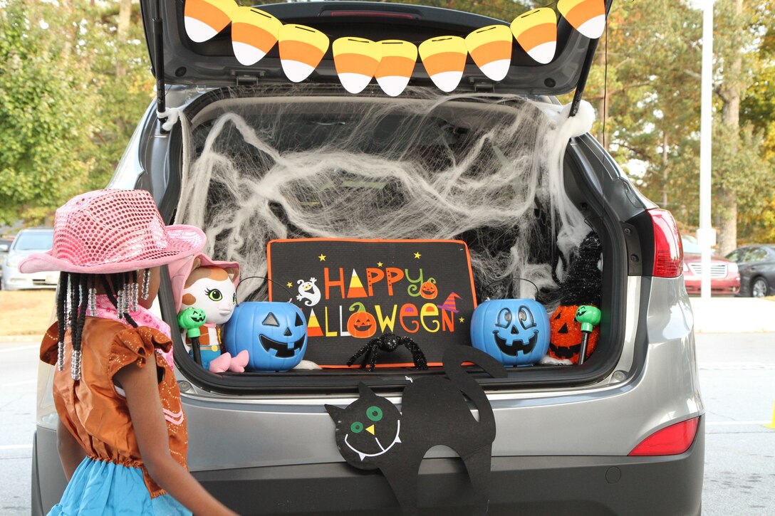 Elementary school children attend the Trunk or Treat event at Church Street Elementary School where 3d MCDS Soldiers, members of the Fire Department and Riverdale Police Department hand out candy.