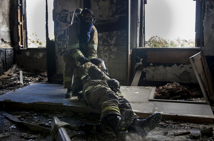 Staff Sgt. Crystal Baetz, a U.S. Army Reserve military police Soldier with the 603rd Military Police Company in Belton, Missouri, drags her 200-pound-plus partner out of harm’s way during a firefighter training simulation at the Highland Park Fire Department in Highland Park, Michigan, Oct. 13. The exercise is designed to train firefighters to find other firefighters who have become immobile and carry them to safety. During the training, Baetz had to wear her usual 80-pound load of gear, carry a full sized fire hose, wear a gas mask and find her partner while wearing a blindfold in order to simulate a building densely filled with smoke and carbon dioxide. Baetz is the first female interior firefighter at that location. She is also a 911 dispatcher and a combatives level four qualified instructor. (U.S. Army Reserve photo by Sgt. Stephanie Ramirez)