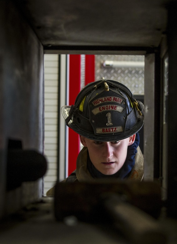 Staff Sgt. Crystal Baetz, a U.S. Army Reserve military police Soldier with the 603rd Military Police Company in Belton, Missouri, prepares her gear before beginning a firefighter training simulation at the Highland Park Fire Department in Highland Park, Michigan, Oct. 13. The exercise is designed to train firefighters to find other firefighters who have become immobile and carry them to safety. During the training, Baetz had to wear her usual 80-pound load of gear, carry a full sized fire hose, wear a gas mask and find her partner while wearing a blindfold in order to simulate a building densely filled with smoke and carbon dioxide. Baetz is the first female interior firefighter at that location. She is also a 911 dispatcher and a combatives level four qualified instructor. (U.S. Army Reserve photo by Sgt. Stephanie Ramirez)