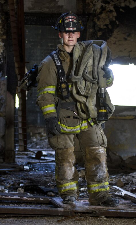 Staff Sgt. Crystal Baetz, a U.S. Army Reserve military police Soldier with the 603rd Military Police Company in Belton, Missouri, poses for a photo after completing a firefighter training simulation at the Highland Park Fire Department in Highland Park, Michigan, Oct. 13. The exercise is designed to train firefighters to find other firefighters who have become immobile and carry them to safety. During the training, Baetz had to wear her usual 80-pound load of gear, carry a full sized fire hose, wear a gas mask and find her partner while wearing a blindfold in order to simulate a building densely filled with smoke and carbon dioxide. Baetz is the first female interior firefighter at that location. She is also a 911 dispatcher and a combatives level four qualified instructor.  (U.S. Army Reserve photo by Sgt. Stephanie Ramirez)