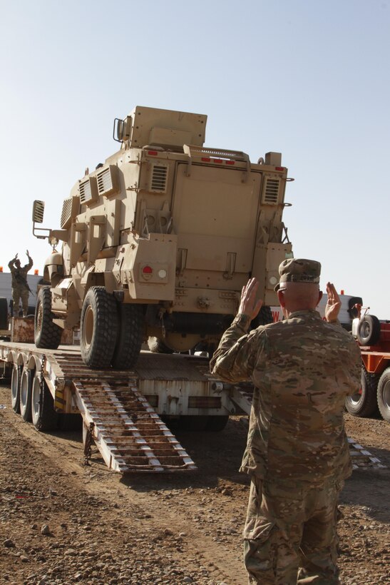 U.S. Army Reserve Warrant Officer 4 John Crane, senior accountable officer,1st Theater Sustainment Command-Operational Command Post, oversees the receipt of an Iraq Train and Equip Fund shipment of vehicles, worth more than $34.3 million, and assists 336th Combat Support Sustainment Battalion soldiers in accounting for and dismounting them, at an undisclosed location in Iraq, Sept. 24, 2016. .The mine resistant ambush protected vehicles, also known as MRAPs, and water trucks are scheduled to be donated to the Iraqi security forces to help them fight Da’esh.