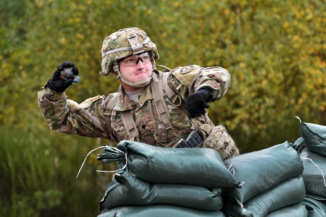 A soldier throws a training hand grenade during training to qualify for the Expert Infantryman Badge at the Grafenwoehr Training Area in Germany, Oct. 20, 2016. Army photo by Spc. Nathanael Mercado