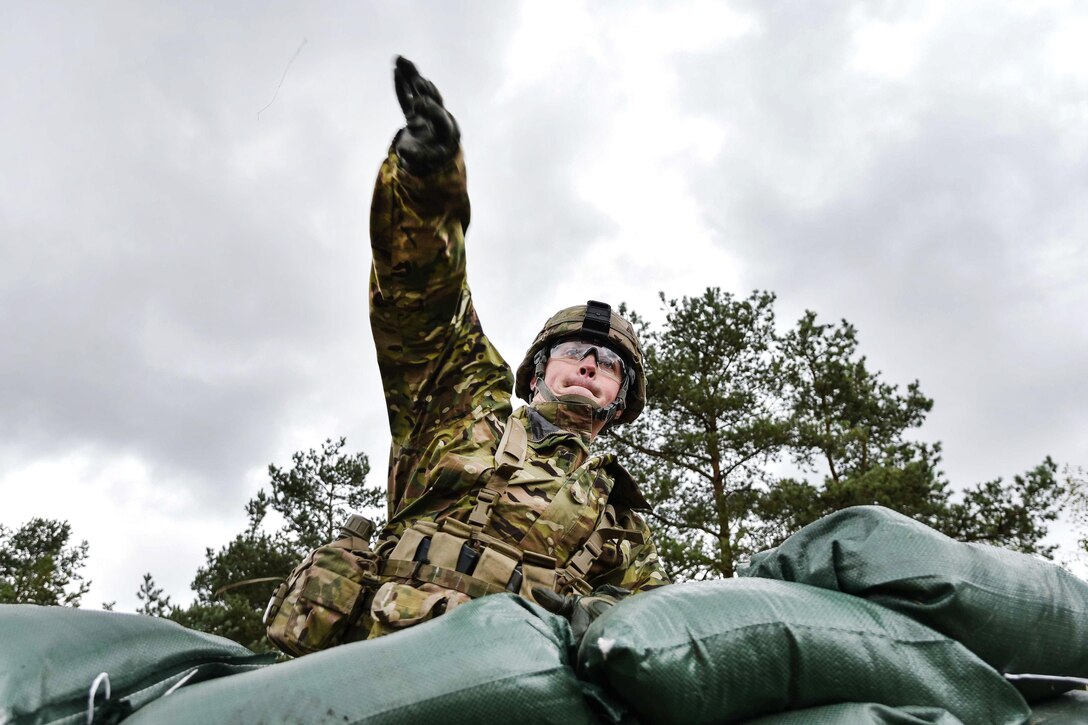 A soldier throws a training hand grenade during training to qualify for the Expert Infantryman Badge at the Grafenwoehr Training Area in Germany, Oct. 20, 2016. Army photo by Spc. Nathanael Mercado